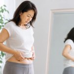 お腹を気にする女性